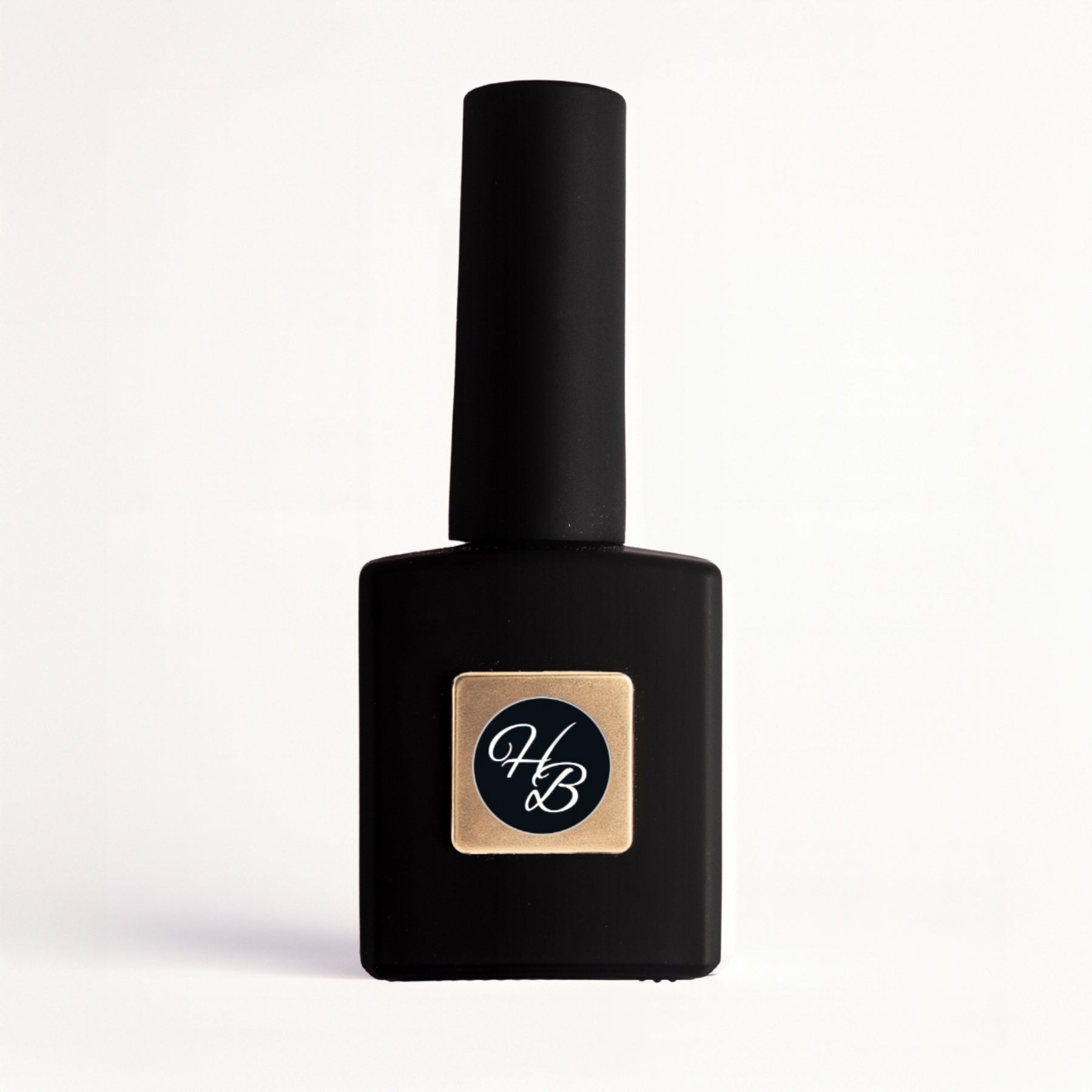 Black nail polish bottle with a gold and black label on a white background