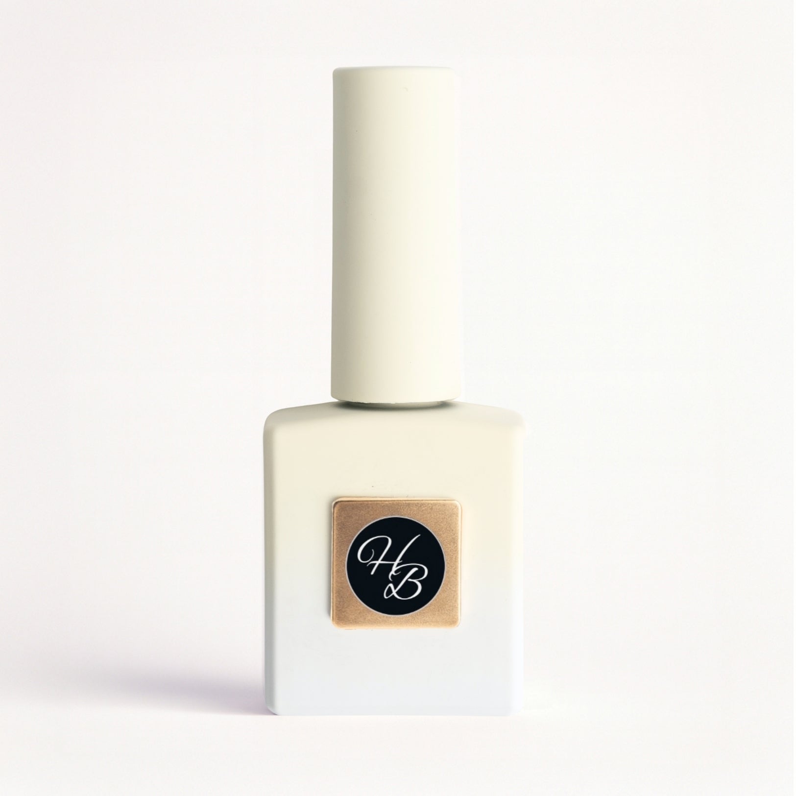 White nail polish bottle with a gold label and black logo on a white background