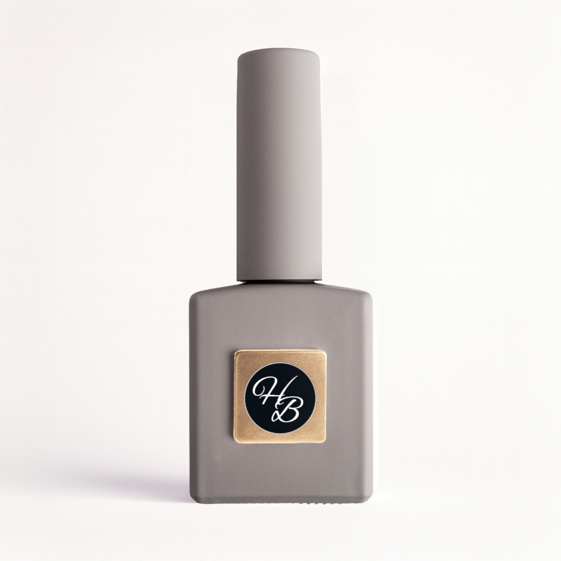 Gray nail polish bottle with gold label on a white background